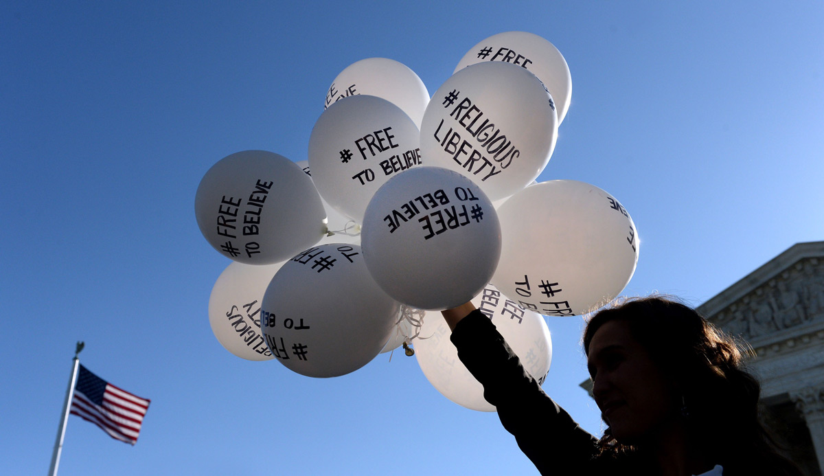 A protestor holds balloons calling for religious freedom outside the US Supreme Court. Olivier Douliery/Getty Images.
