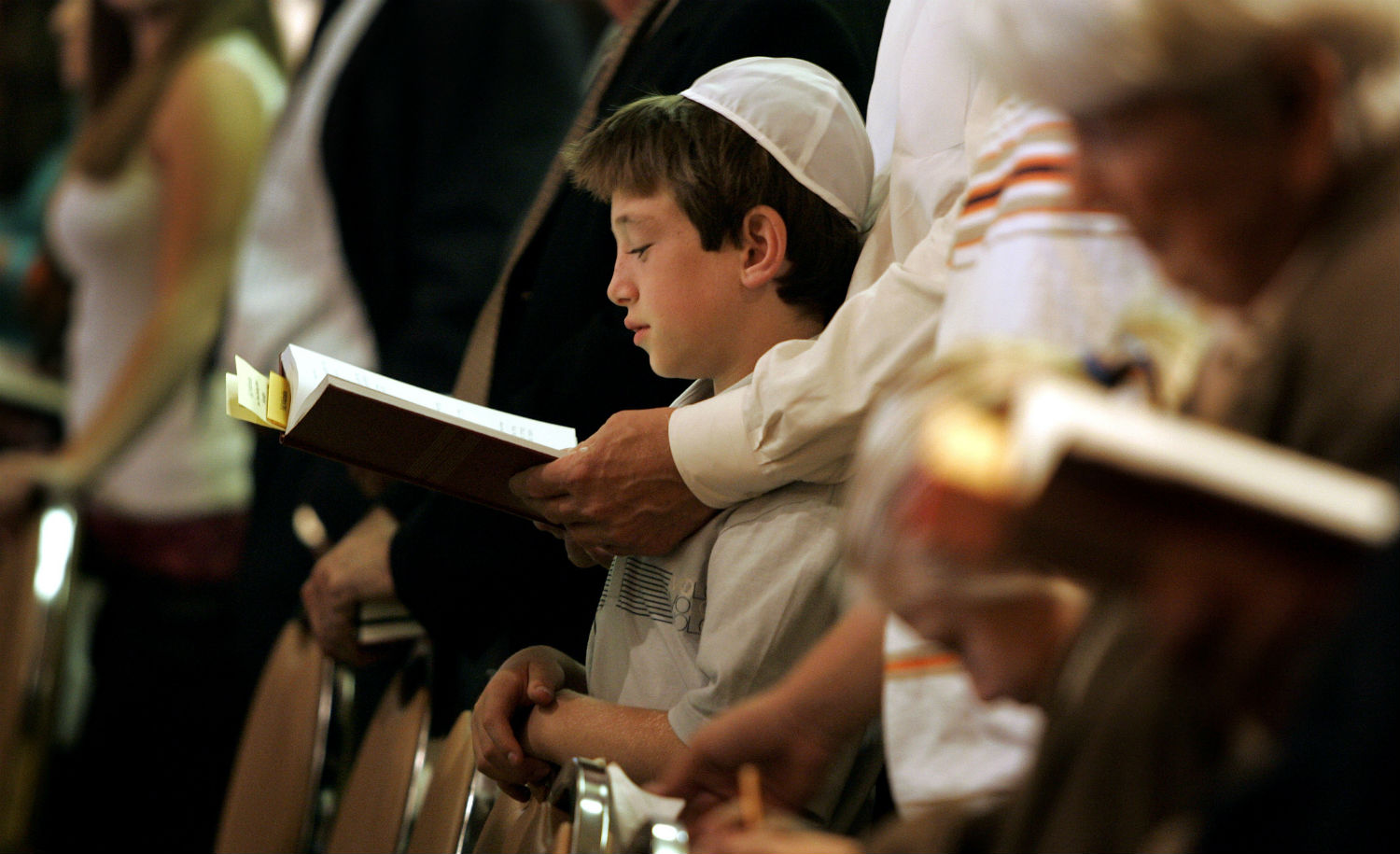 
A father and son praying. Gina Ferazzi/Los Angeles Times via Getty Images.

