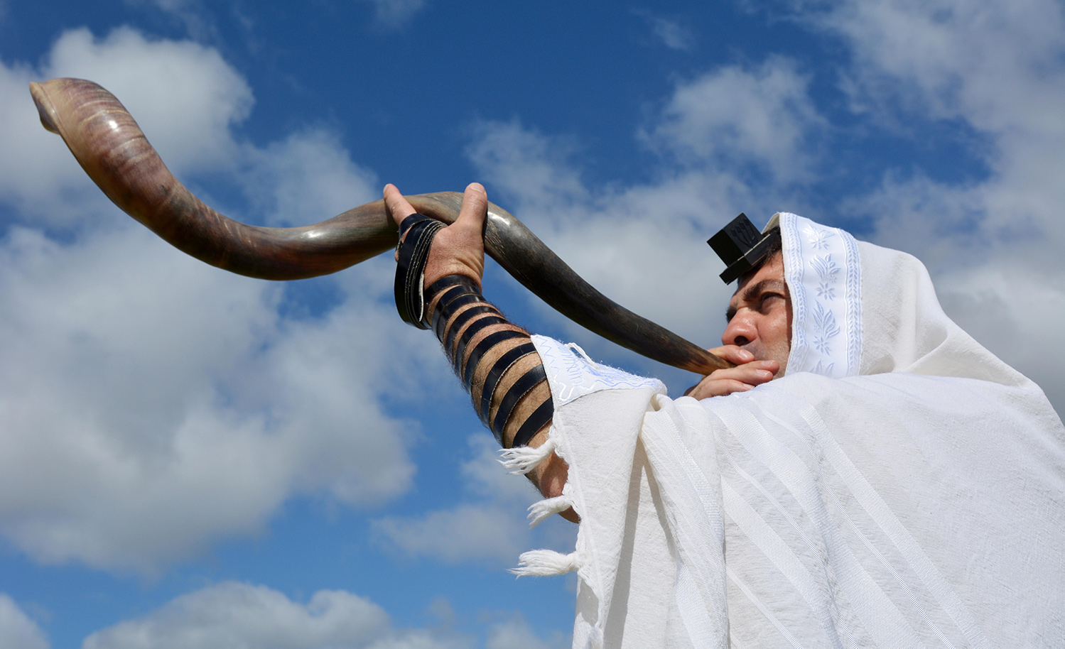 A jew blowing the shofar - a ram's horn.