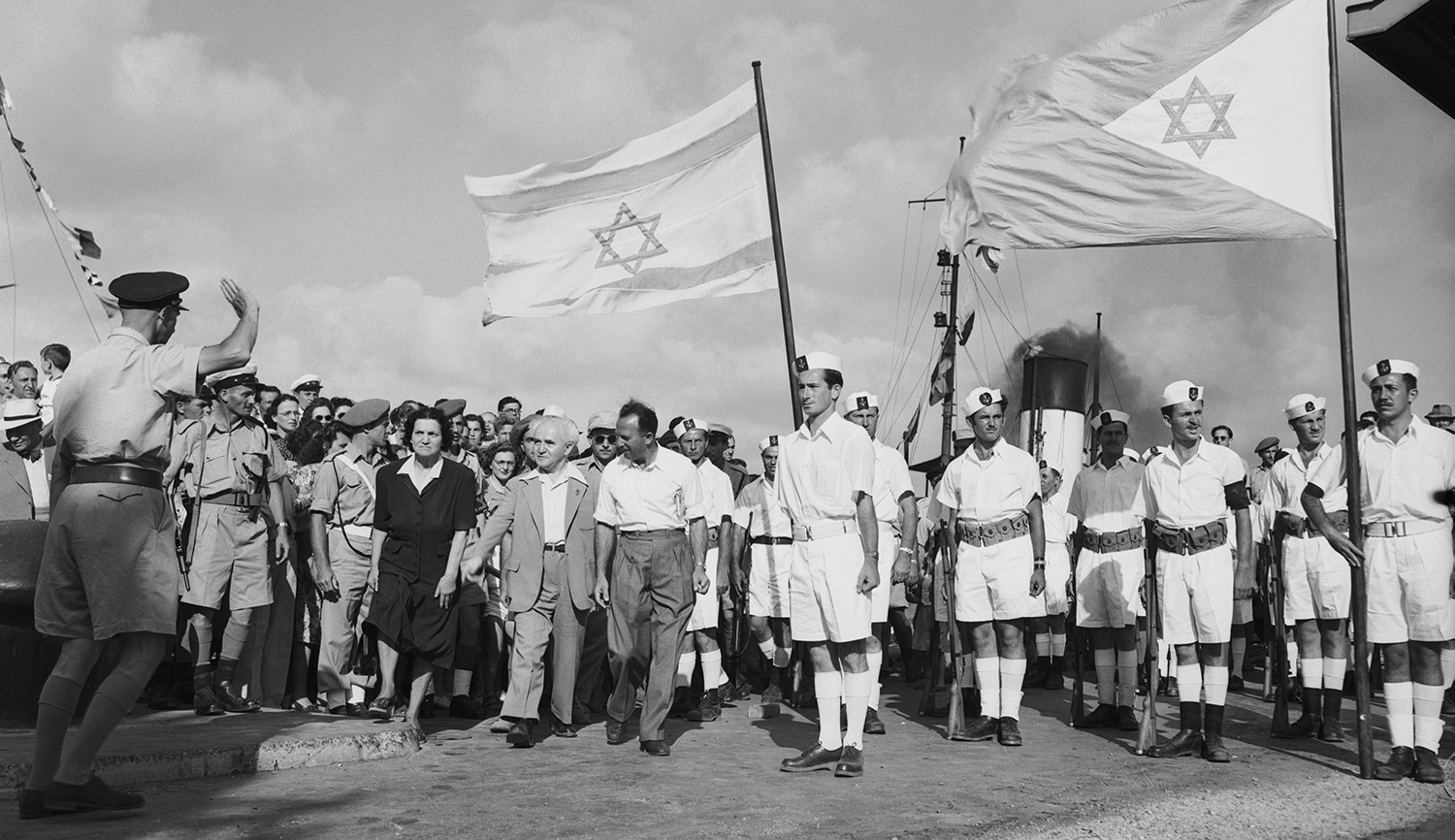 David Ben-Gurion with his wife and others at the Haifa docks to see the last contingent of British troops leave Israel on July 4, 1948. Bettmann/Getty.

