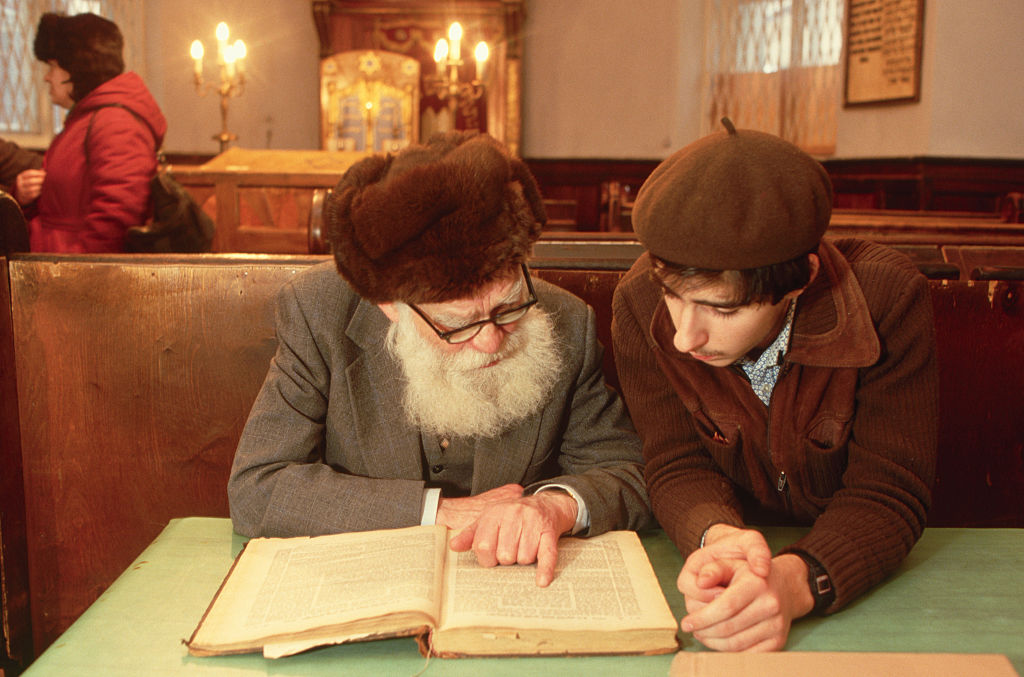 A young man studies with an older one in a Moscow synagogue. Photo by Peter Turnley/Corbis/VCG via Getty Images.
