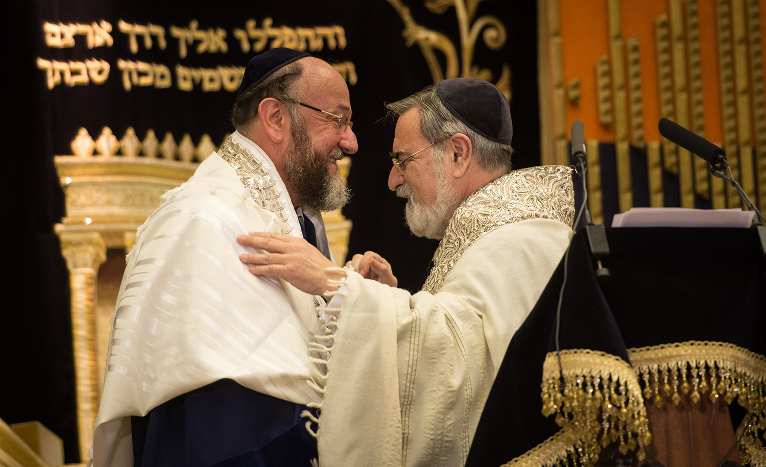 Rabbi Lord Jonathan Sacks, right, congratulates Ephraim Mirvis, his successor as chief rabbi of the United Hebrew Congregations of the UK and the Commonwealth, during a ceremony at the St. John&#8217;s Wood Synagogue in north London on September 1, 2013. STEFAN ROUSSEAU/AFP via Getty Images.
