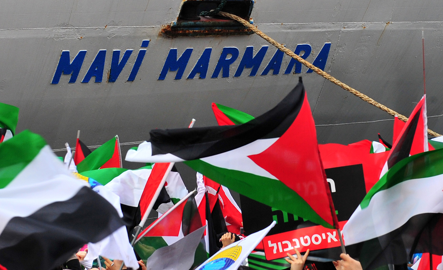The Turkish ship Mavi Marmara arrives at Istanbul&#8217;s Sarayburnu port as people wave Turkish and Palestinian flags on December 26, 2010. MUSTAFA OZER/AFP via Getty Images.
