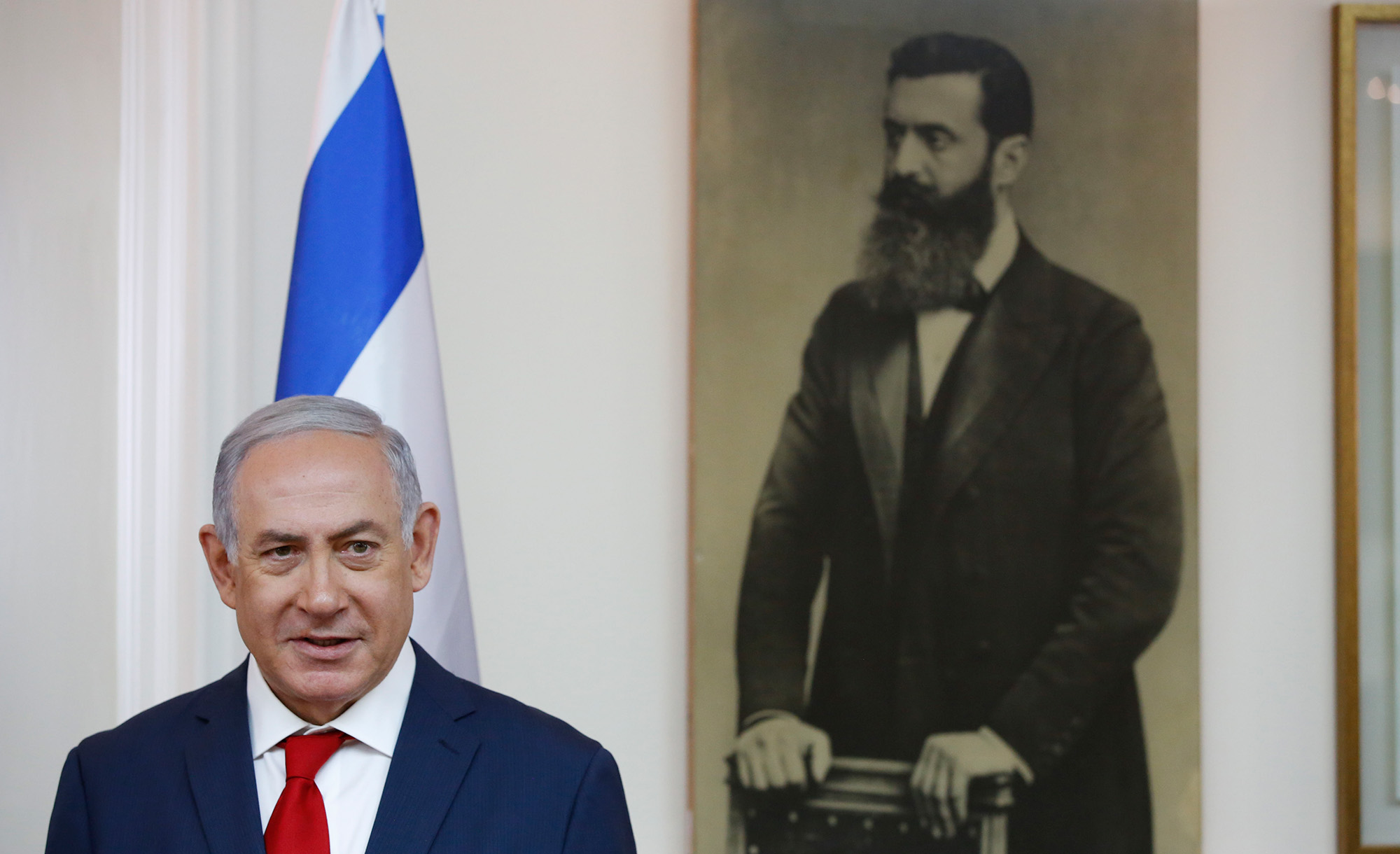 Benjamin Netanyahu by a portrait of Theodor Herzl on May 2, 2018. ABIR SULTAN/POOL/AFP via Getty Images.
