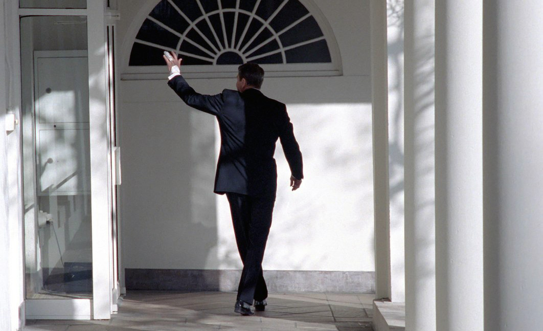 Ronald Reagan walking along the White House colonnade and waving goodbye on his last day in office, January 20, 1989. Alamy/Wonderstock.
