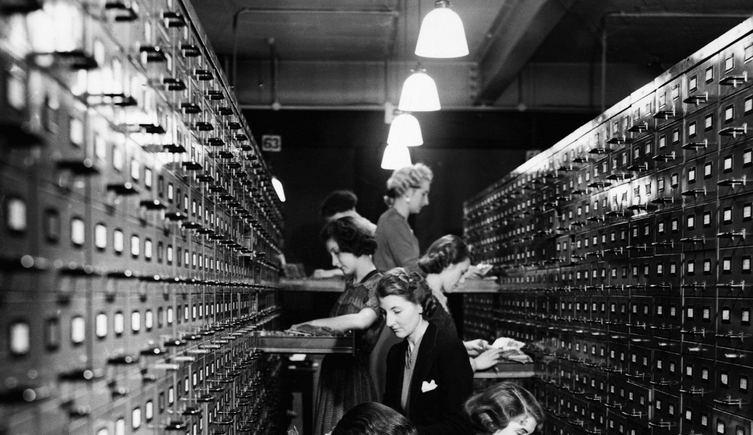 Government workers file index cards for the issue of defense bonds by the National Savings Branch Money Order Department of the General Post Office in 1939. Hulton-Deutsch/Hulton-Deutsch Collection/Corbis via Getty Images.

