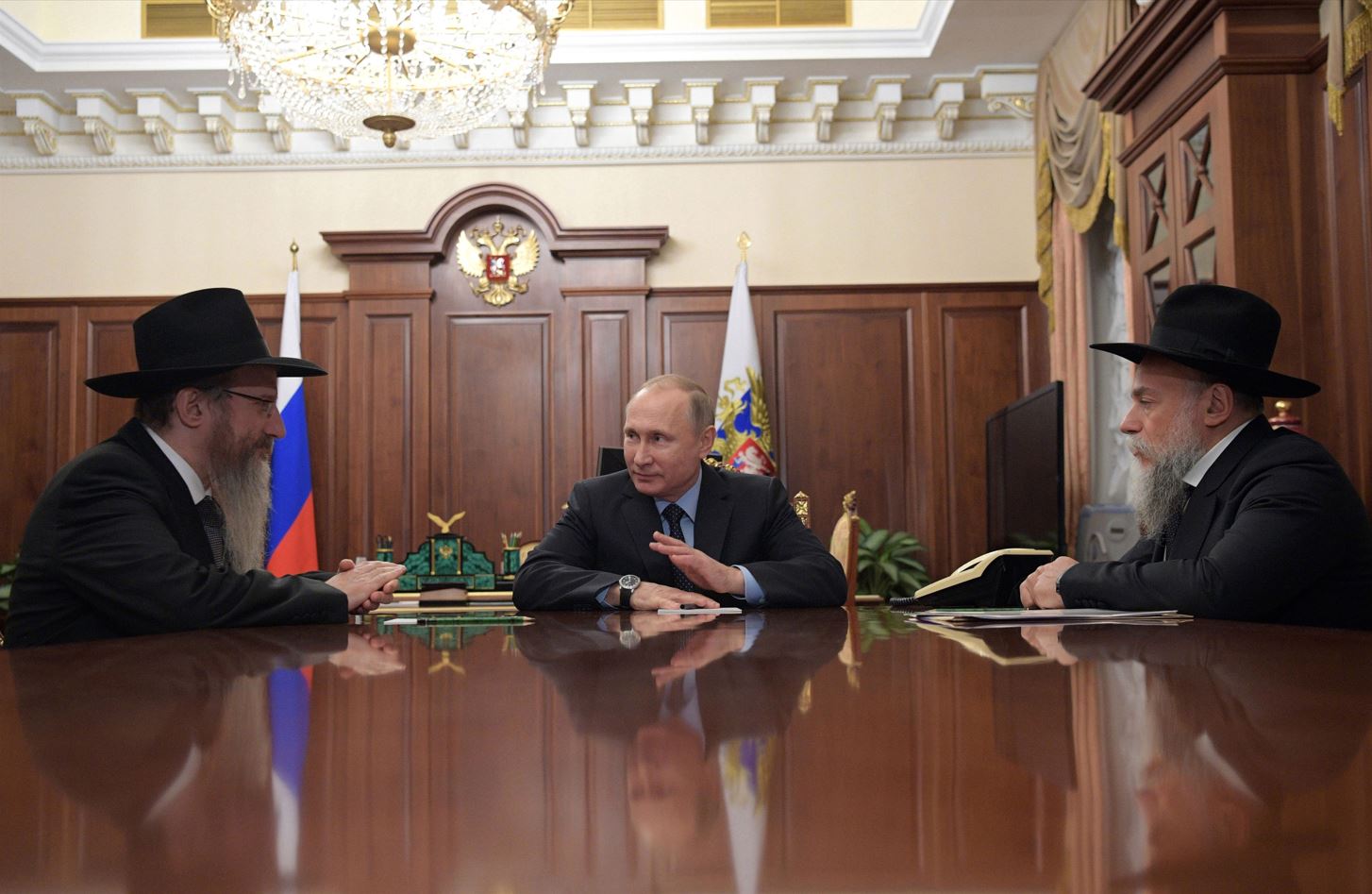 Vladimir Putin speaks with Berel Lazar, the chief rabbi of Russia, and Alexander Boroda, head of the Jewish Communities&#8217; Federation, in Moscow in 2016. ALEXEI DRUZHININ/AFP via Getty Images.
