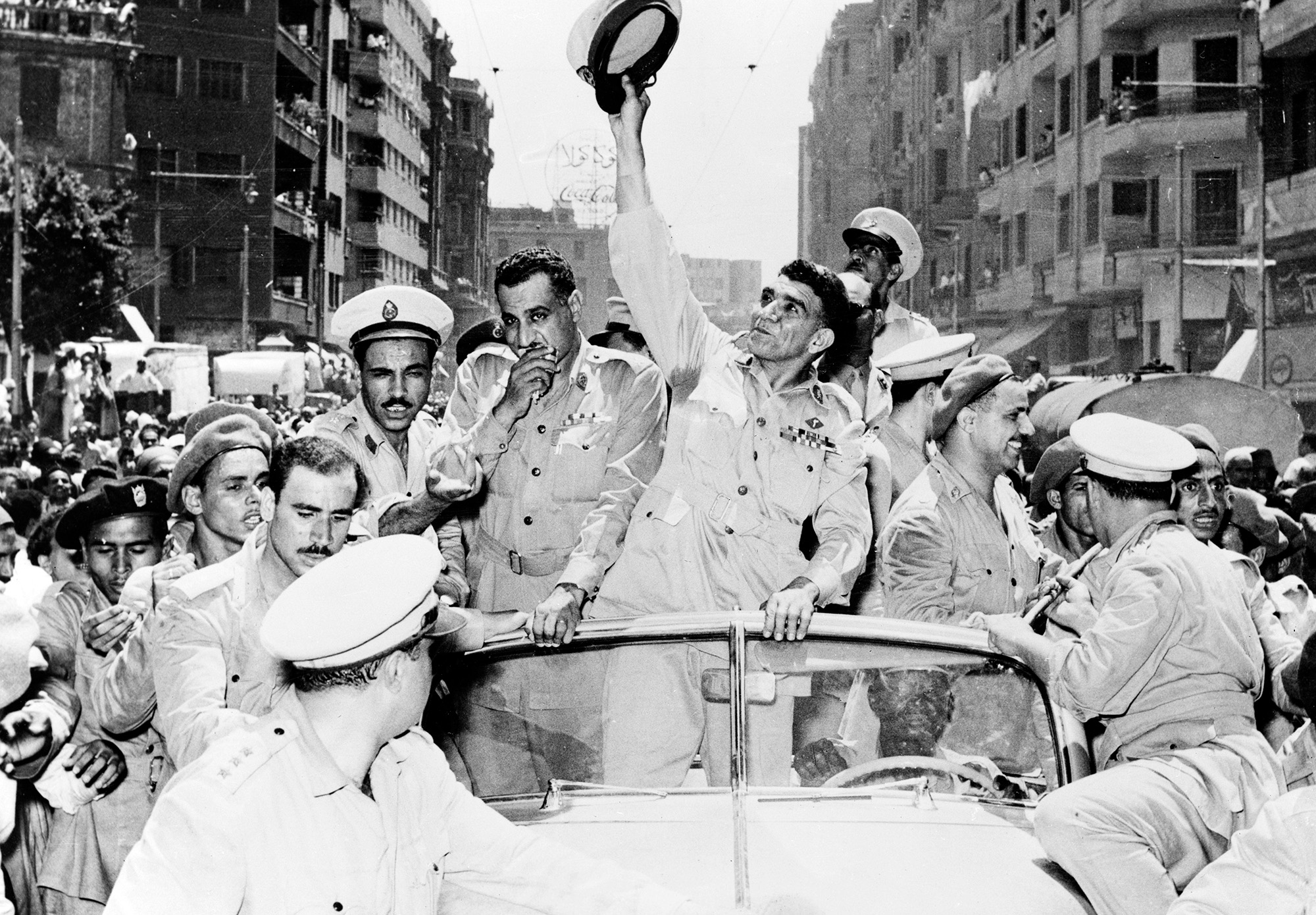 
General Mohammed Naguib, center, and Gamal Abdel Nasser, left, ride through Cairo in a cavalcade celebrating Egypt&#8217;s change from a monarchy to a republic on June 20, 1953. Keystone/Hulton Archive/Getty Images.






