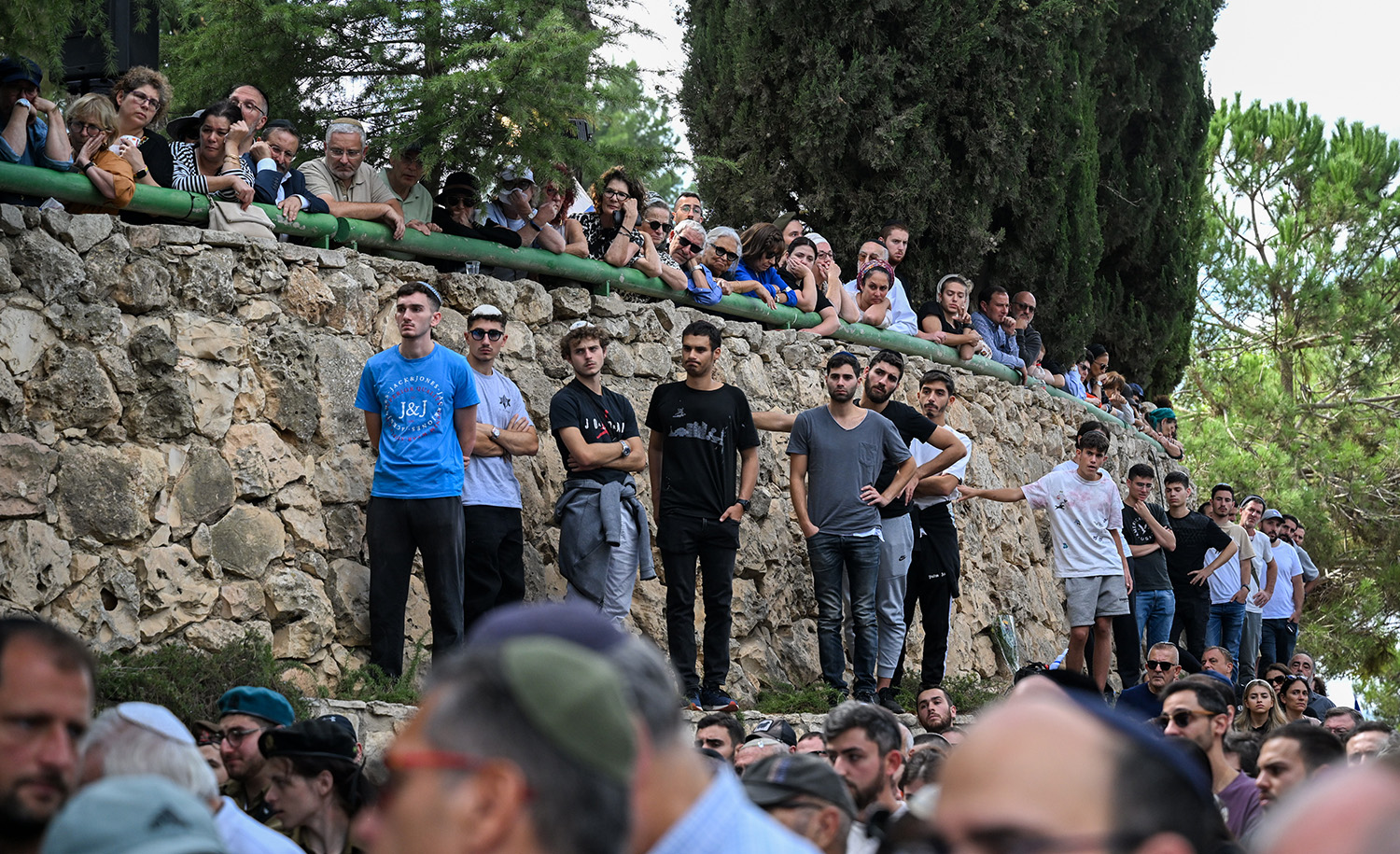 Mourn at the funeral of Valentin (Eli) Ghnassia, 23, killed in a battle with Palestinian militants at Kibbutz Be’eeri, on October 12, 2023 at Mount Herzl Military Cemetery in Jerusalem. Alexi J. Rosenfeld/Getty Images.
