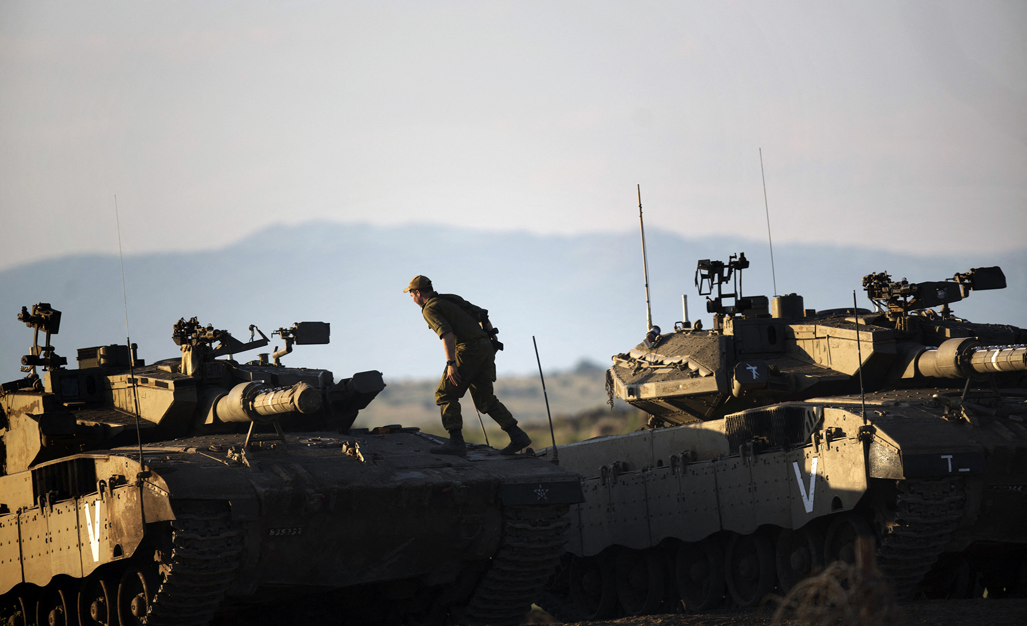 
An Israeli soldier stands on top of a Merkava tank in the Golan Heights on May 5, 2013. MENAHEM KAHANA/AFP via Getty Images.






