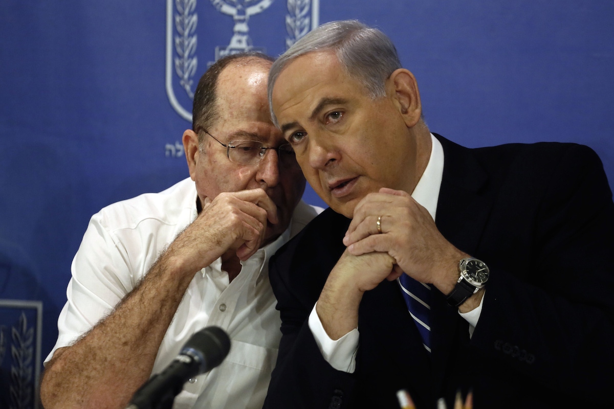 Israeli Prime Minister Benjamin Netanyahu listens to Defense Minister Moshe Yaalon during a cabinet meeting on August 24, 2014. Photo by GALI TIBBON/AFP/Getty Images.
